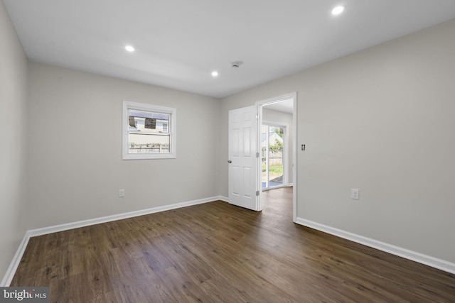 empty room with recessed lighting, baseboards, and dark wood finished floors