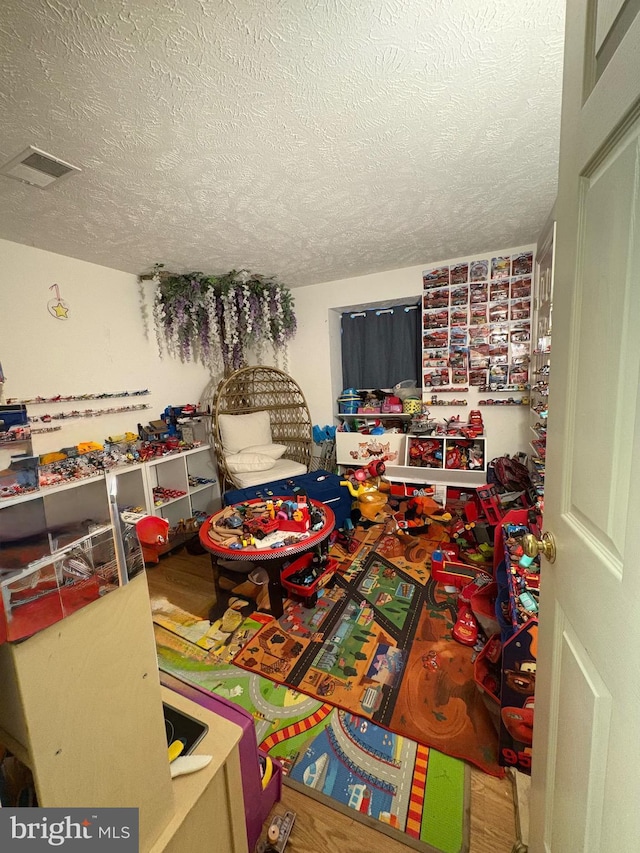 playroom with a textured ceiling and visible vents