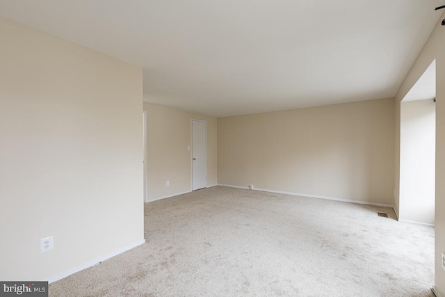 unfurnished room featuring baseboards and carpet floors