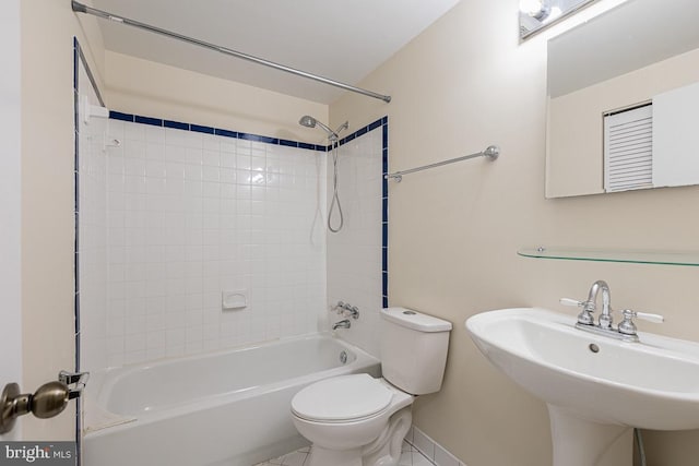 full bath with a sink,  shower combination, toilet, and baseboards