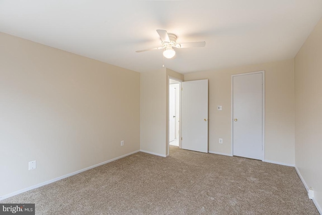 unfurnished bedroom with carpet floors, baseboards, and a ceiling fan