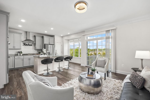 living area with recessed lighting, baseboards, and dark wood-style floors