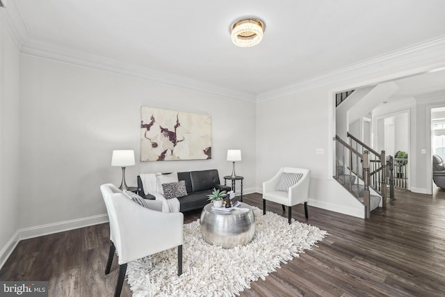 living area featuring baseboards, ornamental molding, stairs, and wood finished floors