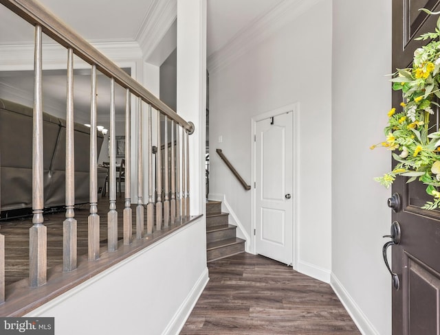 stairs featuring crown molding, baseboards, and wood finished floors