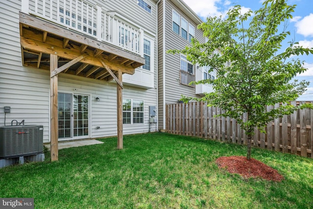 view of yard with fence and central AC unit