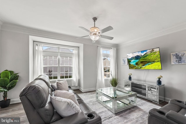 living room with crown molding, a ceiling fan, baseboards, and wood finished floors