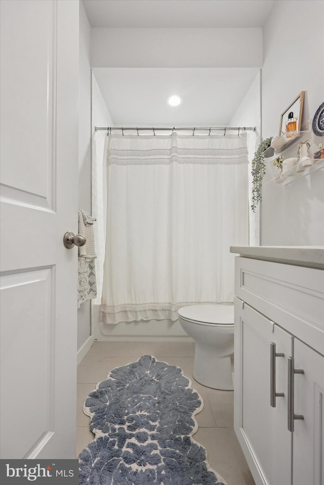 bathroom with tile patterned floors, vanity, toilet, and shower / tub combo
