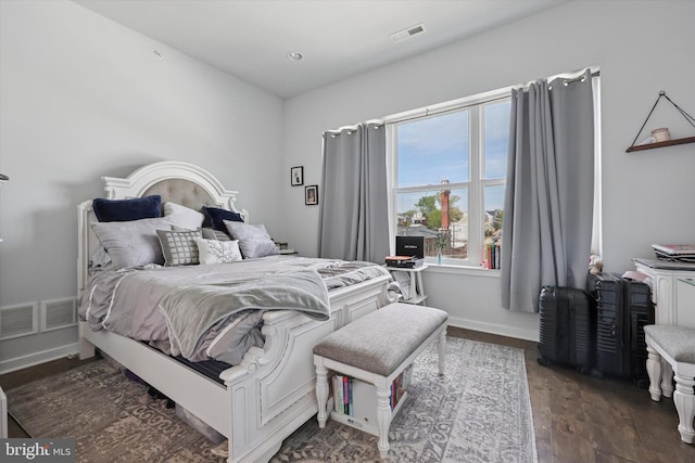 bedroom with visible vents and dark wood-style flooring