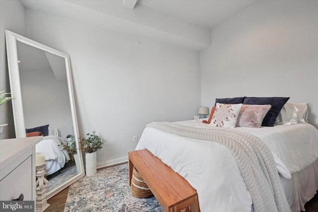 bedroom with baseboards and wood finished floors