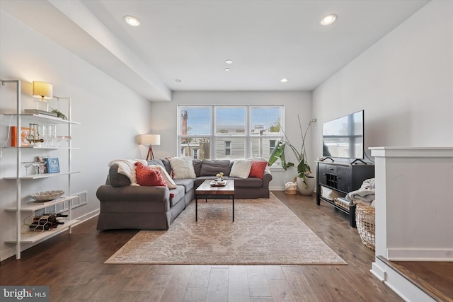 living room featuring recessed lighting, baseboards, and wood finished floors