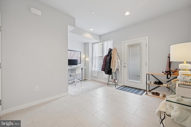 foyer with recessed lighting and baseboards