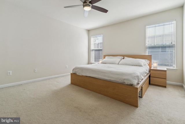 bedroom featuring baseboards, ceiling fan, and light colored carpet