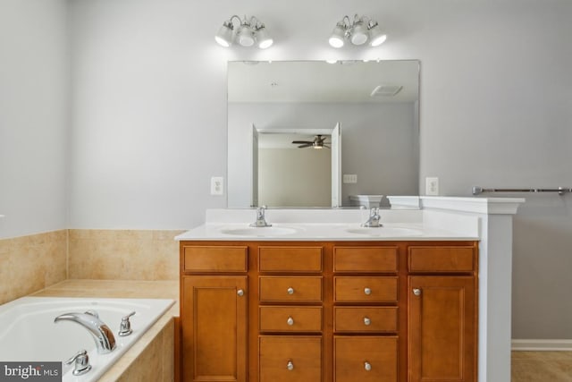 bathroom featuring double vanity, a ceiling fan, a sink, and a bath