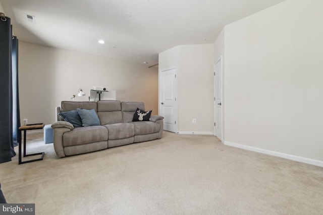living area featuring baseboards, visible vents, recessed lighting, and light colored carpet