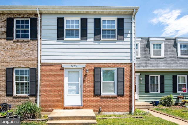 townhome / multi-family property featuring brick siding