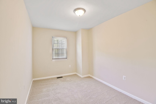 carpeted empty room with baseboards and visible vents
