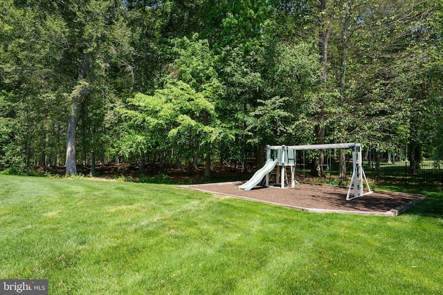 community jungle gym featuring a lawn
