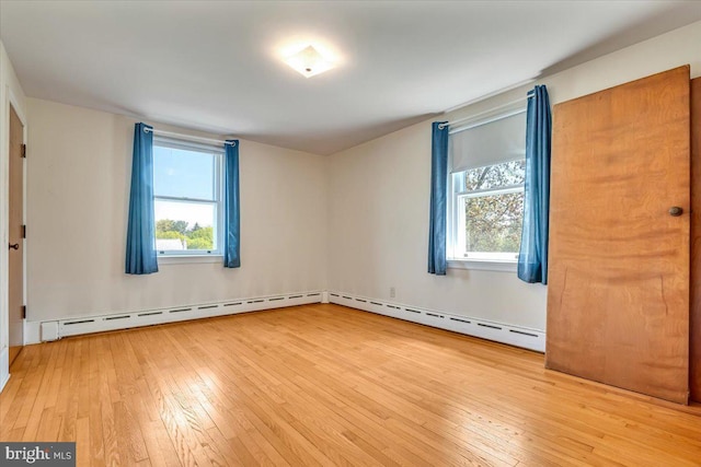unfurnished bedroom featuring multiple windows and hardwood / wood-style flooring