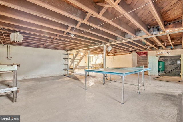 rec room featuring unfinished concrete flooring