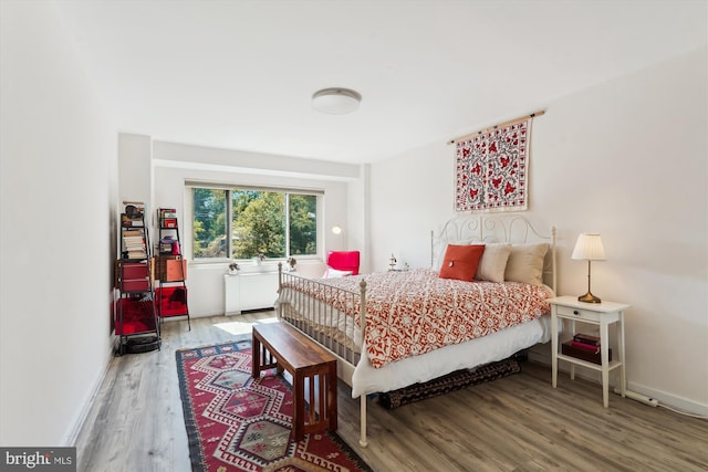 bedroom featuring baseboards and wood finished floors