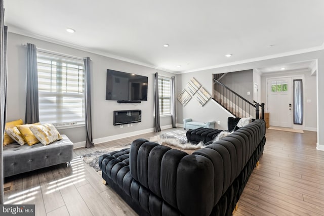 living room featuring crown molding, recessed lighting, wood finished floors, and stairway