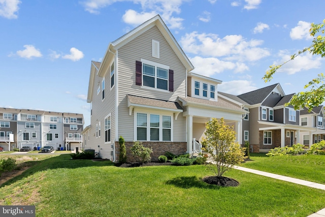 view of front facade featuring a front lawn and stone siding