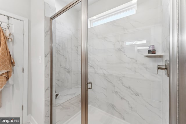 full bathroom featuring a marble finish shower