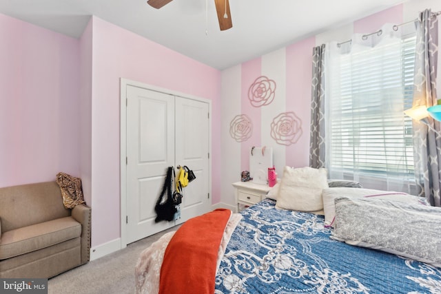 bedroom with a closet, carpet, ceiling fan, and baseboards