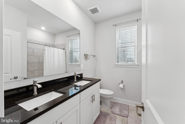 full bath with a sink, tile patterned floors, toilet, and visible vents