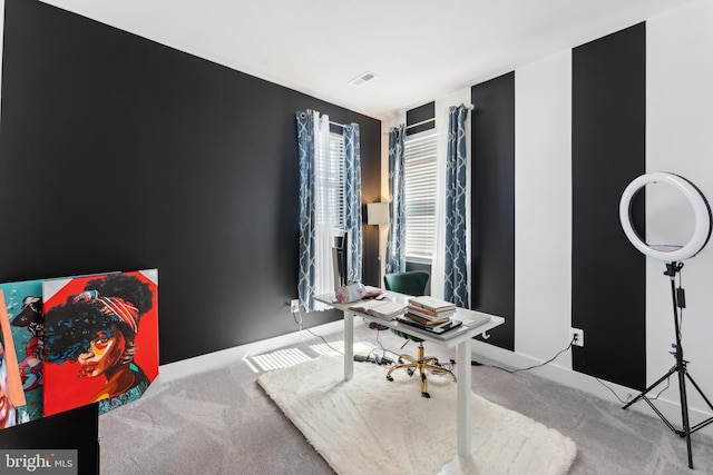 carpeted office featuring baseboards and visible vents