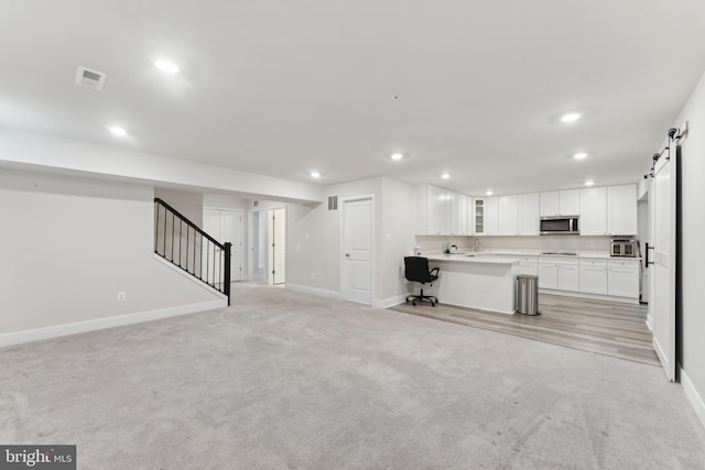unfurnished living room with light carpet, recessed lighting, baseboards, visible vents, and stairway