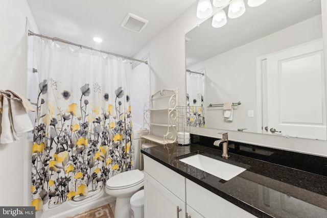 bathroom featuring visible vents, curtained shower, toilet, and vanity