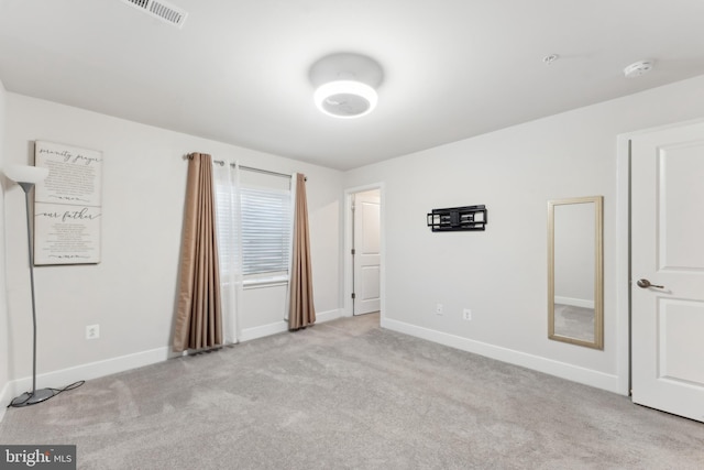 unfurnished bedroom with baseboards, carpet flooring, and visible vents