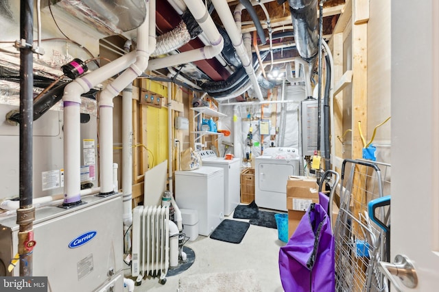 unfinished basement featuring radiator and washing machine and dryer