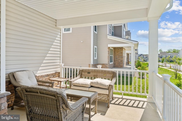 balcony featuring a residential view and covered porch