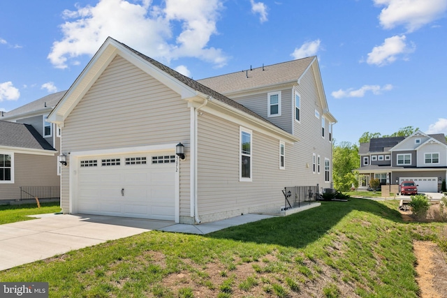 view of property exterior with a yard, an attached garage, and driveway