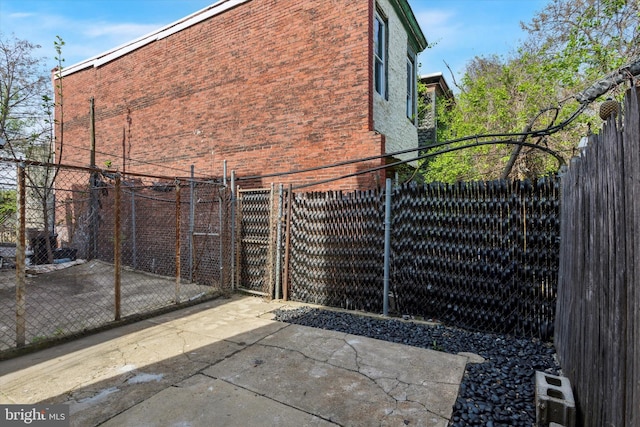2518 N 12th St, Philadelphia, PA 19133 - view of gate featuring a patio and a fenced backyard