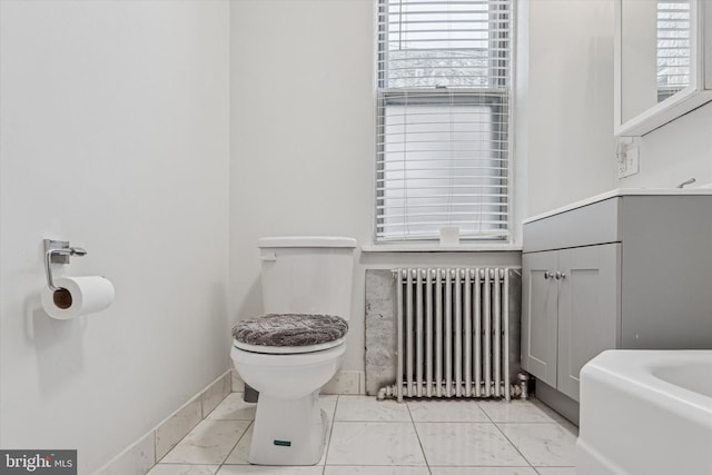 2518 N 12th St, Philadelphia, PA 19133 - bathroom featuring marble finish floor, toilet, plenty of natural light, and radiator