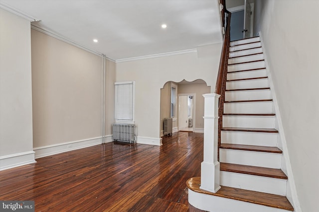 2518 N 12th St, Philadelphia, PA 19133 - stairway with crown molding, arched walkways, radiator heating unit, and hardwood / wood-style flooring