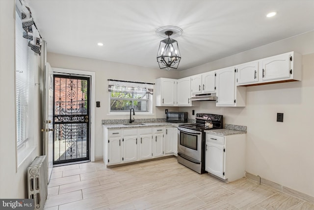 2518 N 12th St, Philadelphia, PA 19133 - kitchen featuring black microwave, radiator heating unit, under cabinet range hood, a sink, and stainless steel electric range oven
