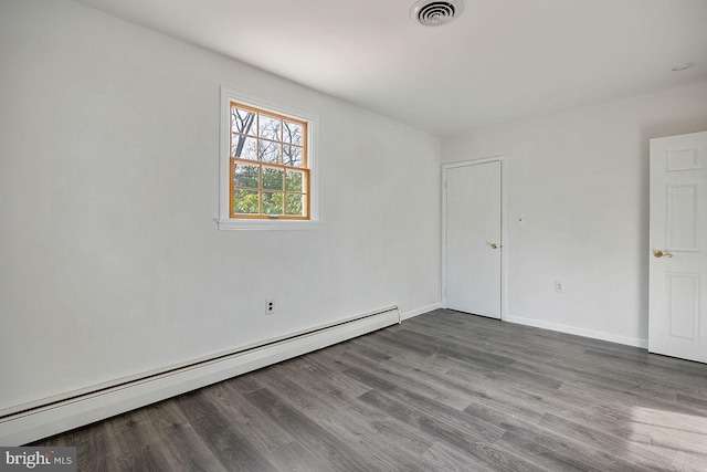 24 Elk Rd, Mullica Hill, NJ 08062 - empty room featuring visible vents, baseboards, a baseboard heating unit, and wood finished floors
