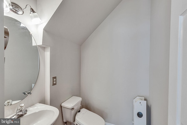 8716 Salinas Ct, Odenton, MD 21113 - bathroom featuring a sink, toilet, and lofted ceiling