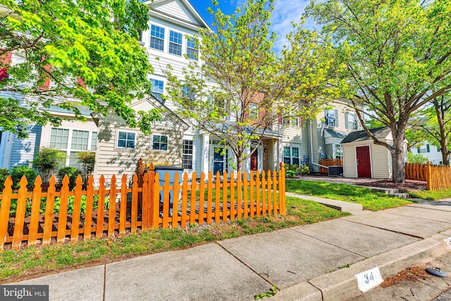 8716 Salinas Ct, Odenton, MD 21113 - view of front of home with a fenced front yard, a storage shed, and an outbuilding