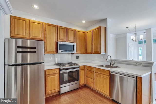 8716 Salinas Ct, Odenton, MD 21113 - kitchen featuring stainless steel appliances, a sink, a peninsula, light countertops, and recessed lighting