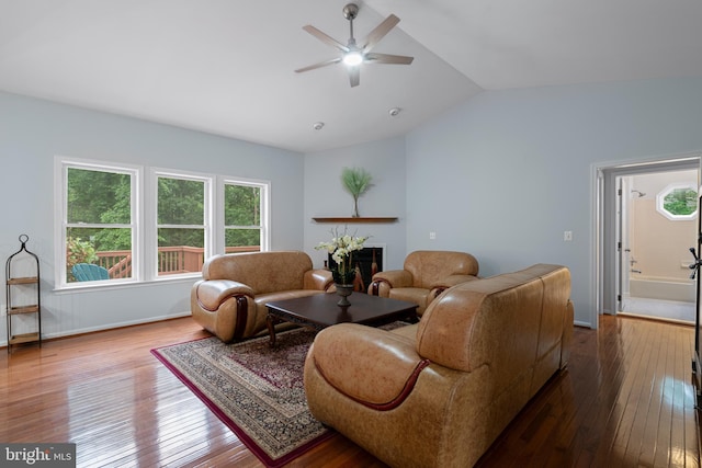 13647 Van Doren Rd, Manassas, VA 20112 - living room featuring dark wood-style flooring, lofted ceiling, a ceiling fan, a fireplace, and baseboards