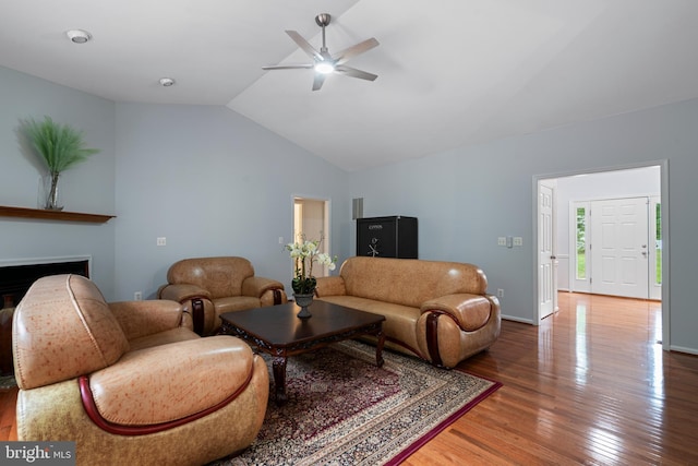 13647 Van Doren Rd, Manassas, VA 20112 - living area featuring wood finished floors, vaulted ceiling, a ceiling fan, a fireplace, and baseboards