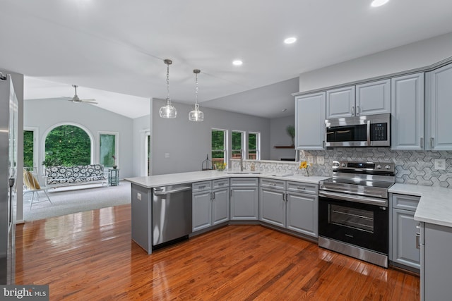 13647 Van Doren Rd, Manassas, VA 20112 - kitchen featuring gray cabinets, stainless steel appliances, a peninsula, dark wood-type flooring, and plenty of natural light