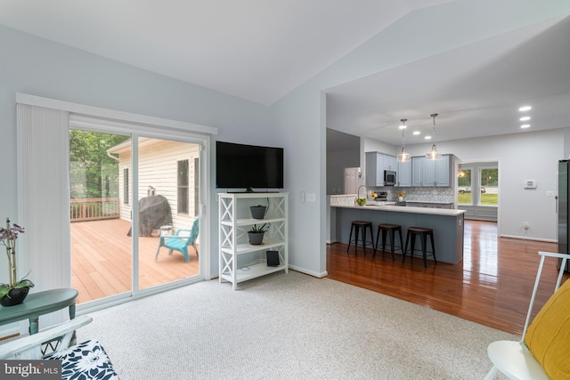 13647 Van Doren Rd, Manassas, VA 20112 - living area with vaulted ceiling, healthy amount of natural light, wood finished floors, and baseboards