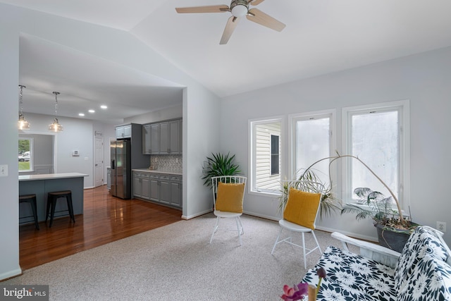 13647 Van Doren Rd, Manassas, VA 20112 - living room featuring dark carpet, vaulted ceiling, a ceiling fan, dark wood-style floors, and baseboards