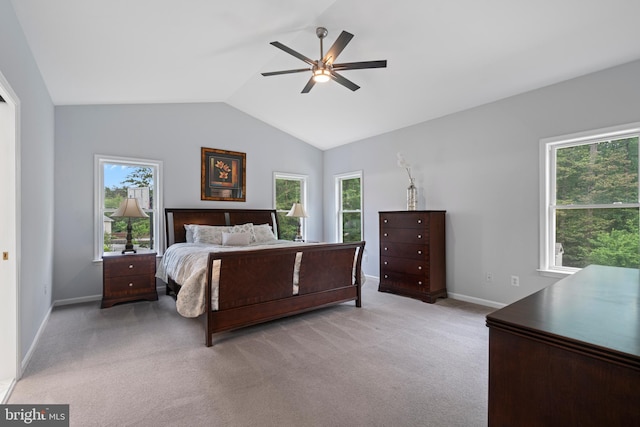 13647 Van Doren Rd, Manassas, VA 20112 - bedroom featuring baseboards, multiple windows, vaulted ceiling, light colored carpet, and a ceiling fan